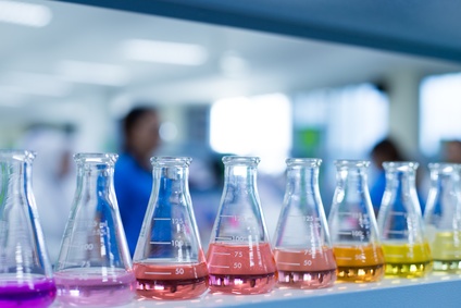 Laboratory with rainbow of liquids in beakers